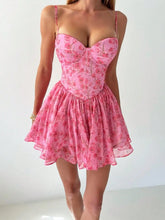 Pink floral dress worn by a person on a white background